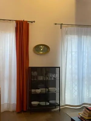 a bedroom with a red bed with a green chair at La Loggia dei Re in Palermo