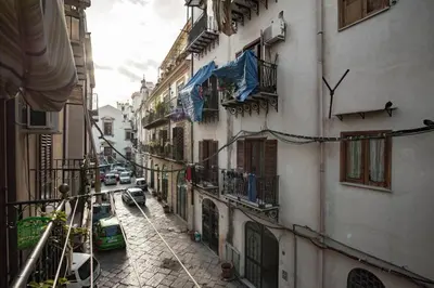 an alley with buildings and cars on a street at Trip Rooms in Palermo