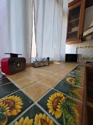 a kitchen with a tile floor with sunflowers on it at PTA Appartamento Girasole in Palermo