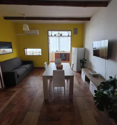 a living room with a table and a couch at PTA Appartamento Girasole in Palermo