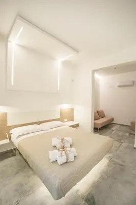 a bedroom with a large bed with towels on it at Oasi del Golfo Suites B&B in Castellammare del Golfo
