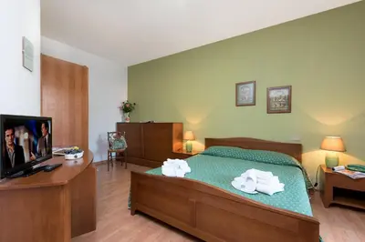 a bedroom with a bed with towels on it at Hotel Halimeda in San Vito lo Capo