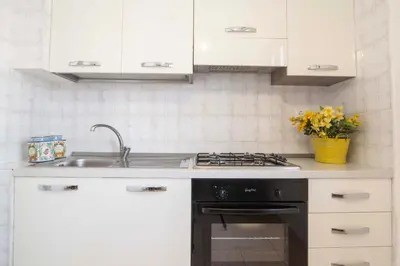 a kitchen with a sink and a stove at Casa Cavour sul Mare in San Vito lo Capo