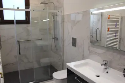 a bathroom with a glass shower and a sink at Palazzo del Golfo in Castellammare del Golfo
