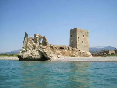 a castle on an island in the water at Giusy's Place 2.0 in Campofelice di Roccella