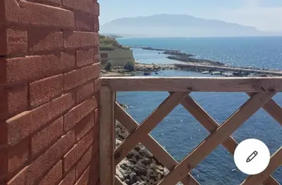a brick wall with a view of the ocean at la casa al mare in Trappeto