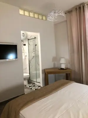 a bedroom with a bed and a tv on a wall at Appartamento di Giò in Palermo