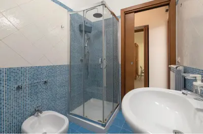 a bathroom with a sink and a glass shower at H Urban in Palermo