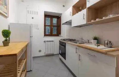 a white kitchen with a stove and a refrigerator at H Urban in Palermo