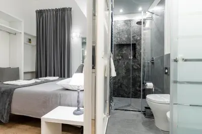 a bathroom with a bed and a shower and a toilet at Residenze Chamur Via Giuseppe Sciuti in Palermo