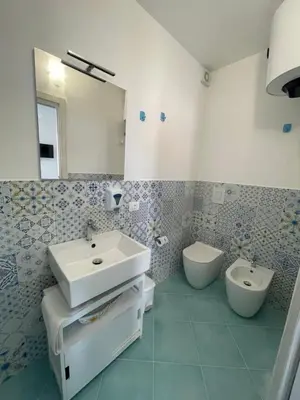 a bathroom with a sink and a toilet at La casa di fronte la spiaggia di San Vito lo capo in San Vito lo Capo