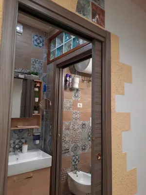 a bathroom with a toilet and a sink at Il Sole della Guilla in Palermo