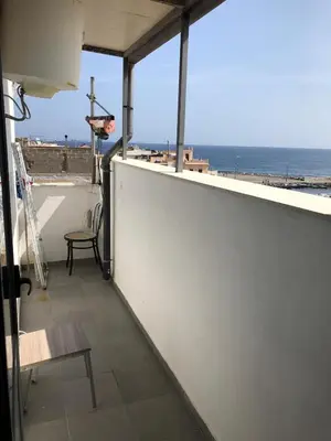 a balcony with a view of the ocean at Casa Nicolina in Palermo