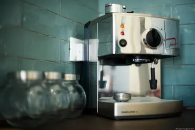 a coffee maker sitting on a counter next to glass jars at Casa Martini Mondello in Palermo