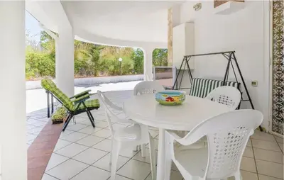 a white dining room with a white table and chairs at Charming Villa in Monreale with Private Pool in Pioppo