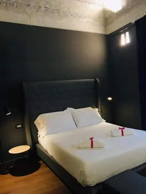 a bedroom with a bed with two white pillows at Palco Noir! in Palermo