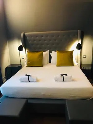 a bedroom with a large bed with two pillows at Palco Noir! in Palermo