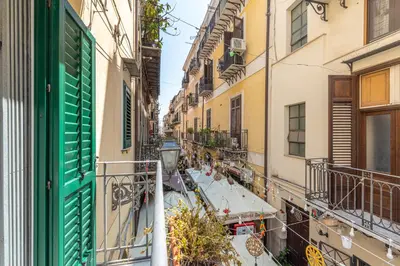 an alley in a city with tables and buildings at Una Finestra sul Teatro Massimo by Wonderful Italy in Palermo