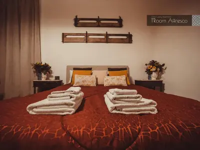 a bedroom with a bed with towels on it at CITRUS LUXURY APARTMENT - holiday apartment with up to 3 bedrooms in palermo center in Palermo