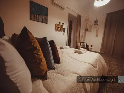 a bedroom with a bed with pillows on it at CITRUS LUXURY APARTMENT - holiday apartment with up to 3 bedrooms in palermo center in Palermo