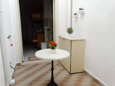 a table with a vase of flowers on it in a room at Holiday Home Sferracavallo in Palermo
