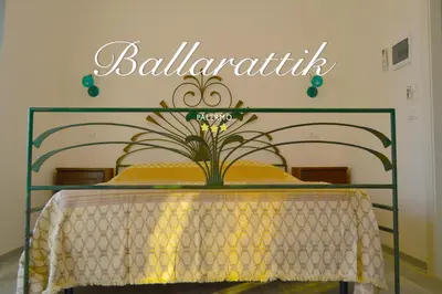 a table and chairs in a room with a view of a building at B&b Ballarattik in Palermo