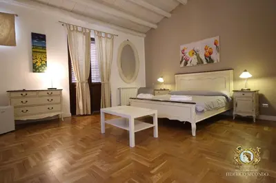 a bedroom with a bed and a table in it at Federico Secondo in Palermo