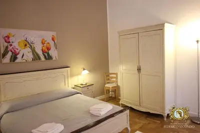a bedroom with a bed with a painting on the wall at Federico Secondo in Palermo