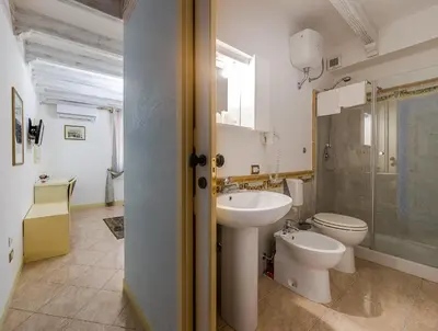 a bathroom with a sink and a toilet and a shower at Hotel Centrale Bagheria in Bagheria