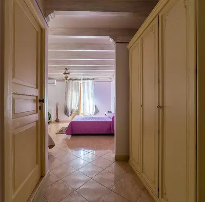 a bedroom with a purple bed in a room at Hotel Centrale Bagheria in Bagheria