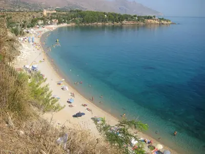 a view of a beach with people in the water at Il Volo Dei Gabbiani in Scopello
