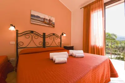 a bedroom with a bed with two towels on it at Aurora Castelluzzo in Castelluzzo