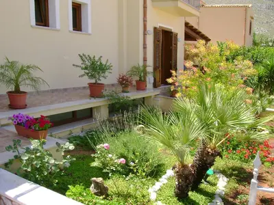 a garden with plants and flowers in a building at Aurora Castelluzzo in Castelluzzo