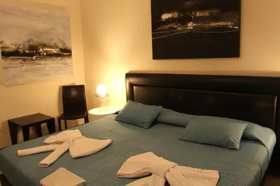 a bedroom with a bed with two towels on it at Abatellis Luxury in Palermo