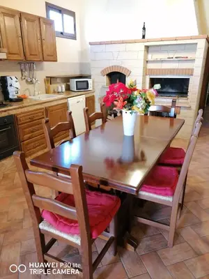 a kitchen with a wooden table with a vase of flowers on it at Paradise in Palermo
