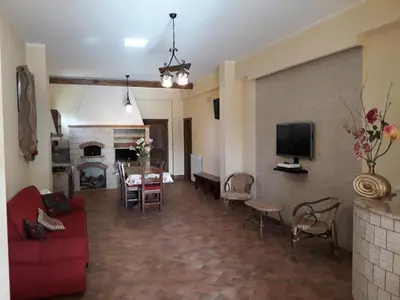 a living room with a red couch and a fireplace at Paradise in Palermo