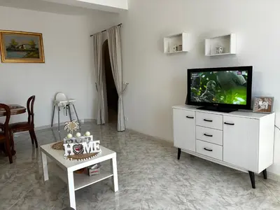 a living room with a tv on a white dresser at Casa Mia in Altavilla Milicia