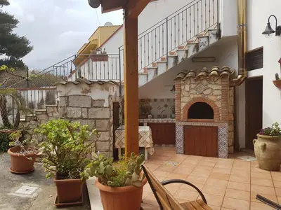 a patio with potted plants and a staircase at VILLA BUTTERFLY 1 sea and history in Capaci