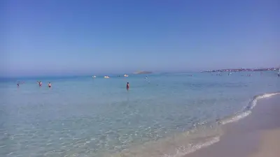 a group of people in the water at the beach at VILLA BUTTERFLY 1 sea and history in Capaci