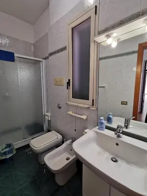 a bathroom with a sink and a toilet and a mirror at Mondello Vista Mare in Mondello