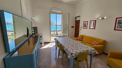 a living room with a table and a couch at Mondello Vista Mare in Mondello