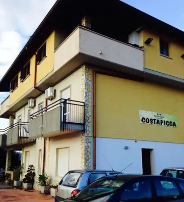 a building with cars parked in front of it at Costapicca in Alcamo