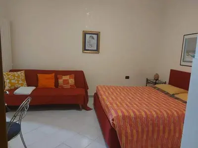 a living room with a couch and a bed at Costapicca in Alcamo