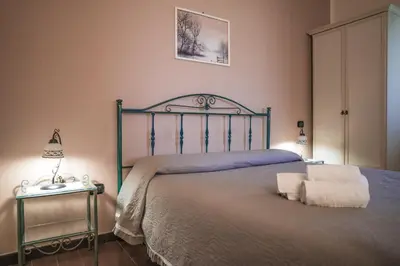 a bedroom with a bed with two towels on it at Piano del Re rooms in Partinico