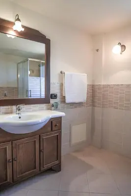 a bathroom with a sink and a mirror at Piano del Re rooms in Partinico