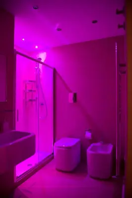 a pink bathroom with a sink and a toilet at White in Palermo
