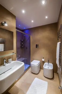 a bathroom with a tub and a toilet and a sink at White in Palermo