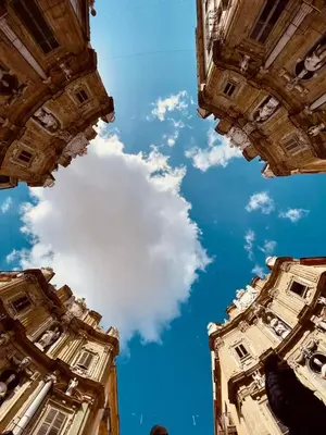 a view of the sky from between two buildings at Casa Del Vicolo Apartament in Palermo