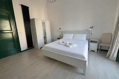 a bathroom with a sink and a toilet and a window at Cosmopolitan Palermo in Palermo
