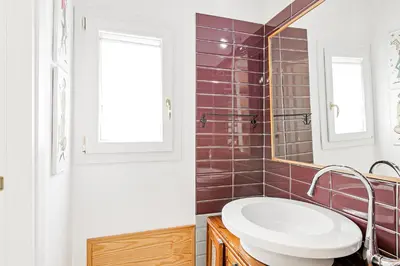 a bathroom with a sink and a mirror at GuestHost - Palazzo dei Normanni Stylish Apartment in Palermo